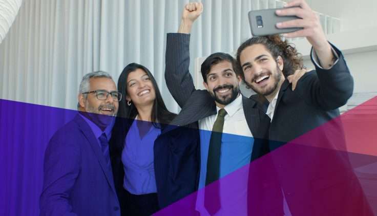 A happy group of employees taking a selfie together