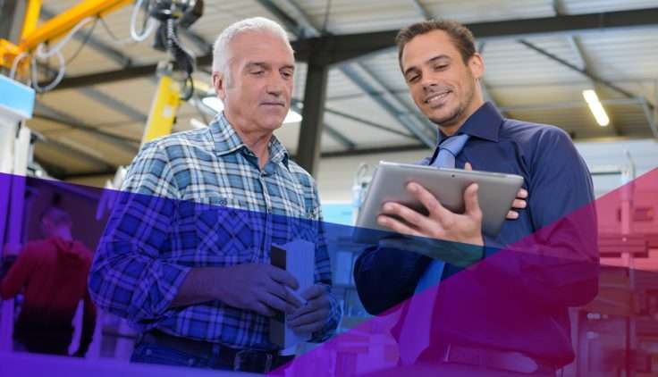 happy collegues reviewing work notes in a warehouse